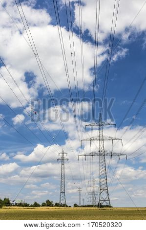 Electric Pylon On  Field Under Blue Sky