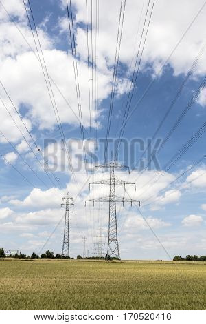 Electric Pylon On  Field Under Blue Sky
