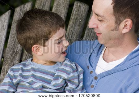 Loving father and his son hugging outside.