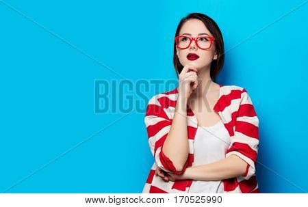 Portrait Of The Beautiful Young Smiling Woman On The Blue Background