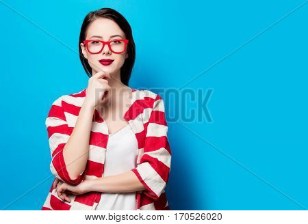 Portrait Of The Beautiful Young Smiling Woman On The Blue Background