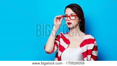 Portrait Of The Beautiful Young Smiling Woman On The Blue Background