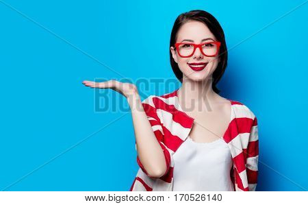 Portrait Of The Beautiful Young Smiling Woman On The Blue Background
