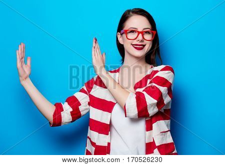 Portrait Of The Beautiful Young Smiling Woman On The Blue Background