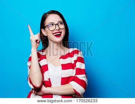 Portrait Of The Beautiful Young Smiling Woman On The Blue Background
