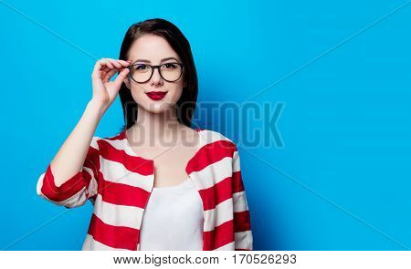 Portrait Of The Beautiful Young Smiling Woman On The Blue Background
