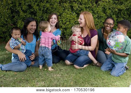 Community of mothers and their children playing.