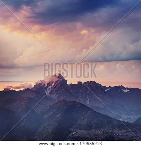 Snow-covered mountains in the mist. Autumn at Koruldi Lake. Europe, Georgia, Upper Svaneti, near mt. Ushba.