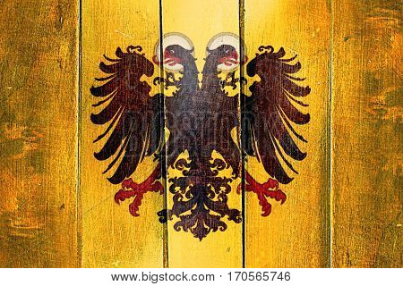 Vintage Holy roman empire flag on grunge wooden panel