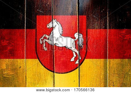 Vintage lower saxony, niedersachsen flag on grunge wooden panel