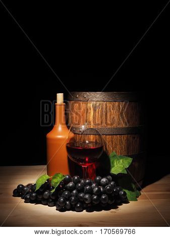 Glass Of Red Wine And Barrel On Wooden Table