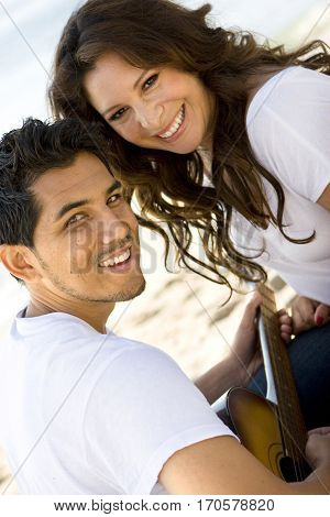 Portrait of a beautiful Hispanic couple laughing and smiling.