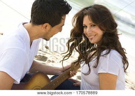 Portrait of a beautiful Hispanic couple laughing and smiling.