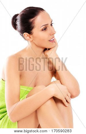 Beautiful woman in towel sitting on the floor
