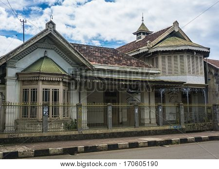 An old house building next to main street with beautiful cloudy sky as background photo taken in Bogor Indonesia java