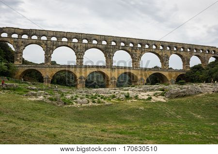 Pont du Gard in Provence France over the Gardon river is an 160 foot high roman aqueduct built to provide water to the city of Nimes from the river Eure near Uzes in the first century A.D.