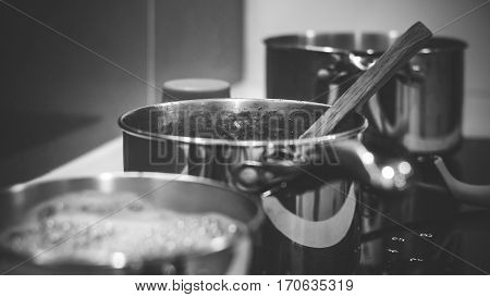 Stove top with row of pots black and white
