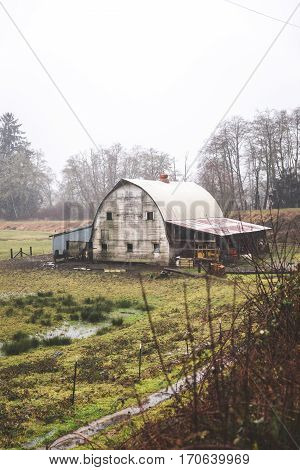 Old barn building in countryside landscape near the Oregon coast. Winter day setting.