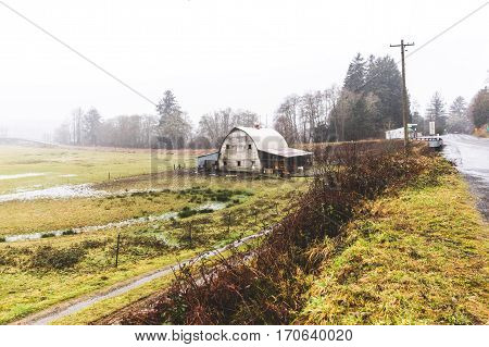Old barn building in countryside landscape near the Oregon coast. Winter day setting.