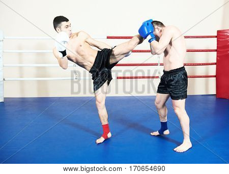 thai sportsman fighting at boxing ring