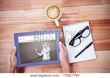 website frontpage against overhead of feminine hands using tablet