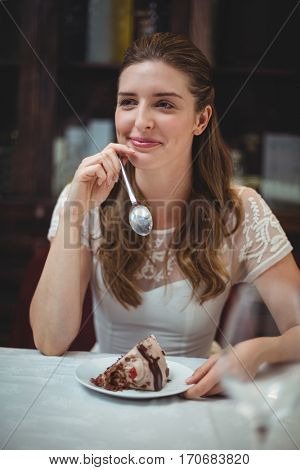 Happy woman with desert in plate at restaurant