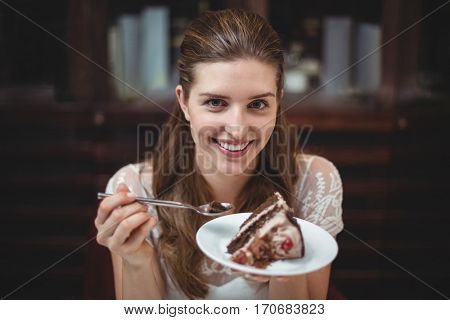 Portrait of smiling woman with desert in restaurant