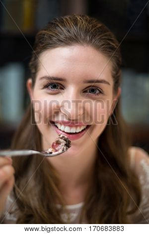 Portrait of happy woman with desert in restaurant