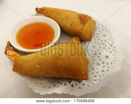 Chinese food in China town Crispy shrimp deep fried spring roll serve with sweet chill in the local traditional Chinese restaurant with blur background