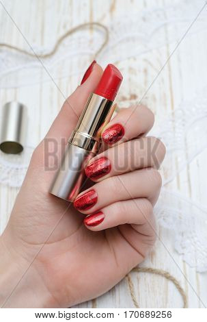 Red nails and red lipstick. Manicure and makeup.