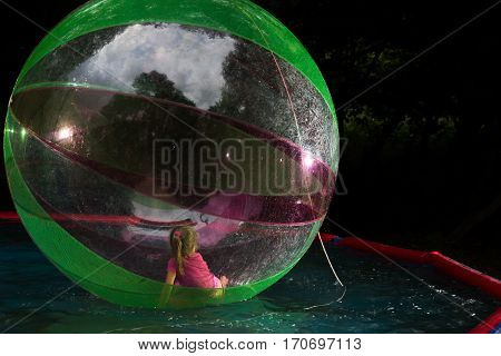 Little Girl In Zorb In The Pool