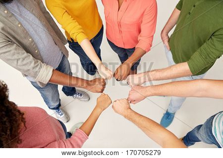 teamwork, friendship, international, gesture and people concept - group of hands making fist bump