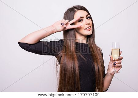 Young girl in black dress drink champagne on white background
