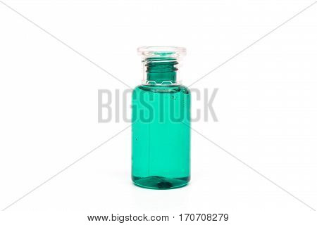 Packaging plastic clear bottle with green liquid on white background (isolated).