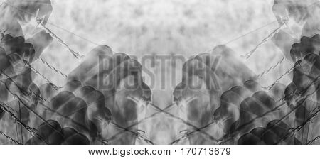 Artistic surreal tortured hands grasping desperately barbed wire (infrared)