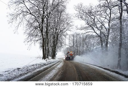 PENKUN GERMANY - JANUAR 06 2017: Gritter lorry with snow plough fitted to the front clearing