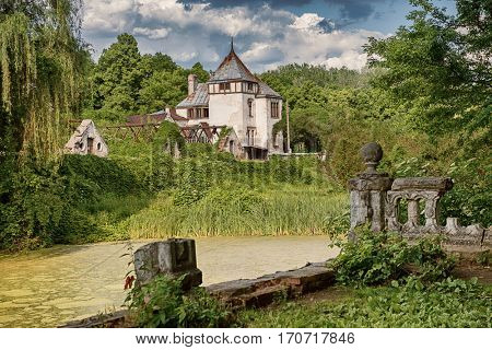 beautiful view of Sharovsky Castle building in amazing green park with lake and sky on the background, Kharkiv region