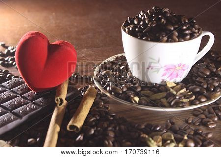 Coffee in a cup and saucer on a wooden background