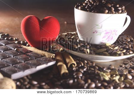 Coffee in a cup and saucer on a wooden background