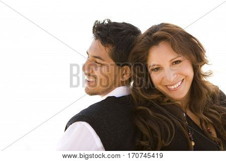 Portrait of a beautiful Hispanic couple laughing and smiling.
