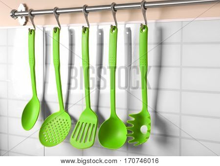 Set of kitchen utensils hanging on the wall