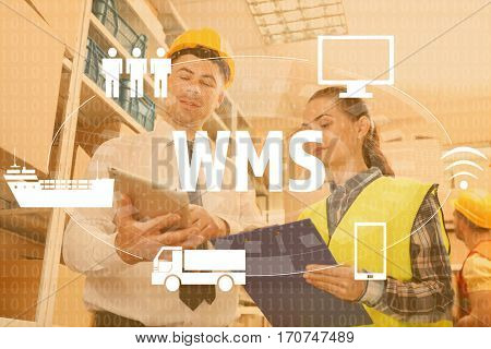 Warehouse management system concept. People working at factory facility