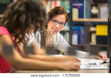 Group of university students studying hard for an exam in a lovely bright sunlit studying room/library