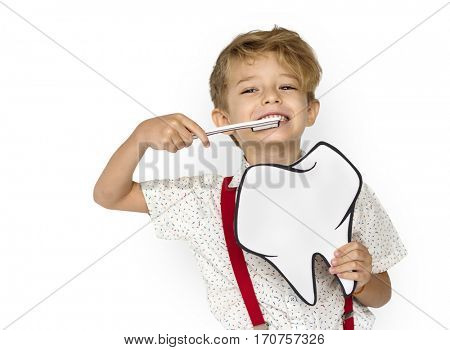 Little Boy Brushing Teeth Holding Papercraft Tooth