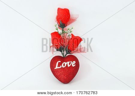 Plastic red roses on a white background.