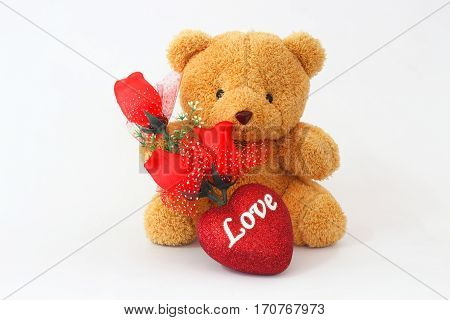 Brown teddy bears and red roses on a white background.