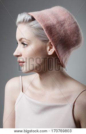 Young woman in retro style wearing hat. Side view.