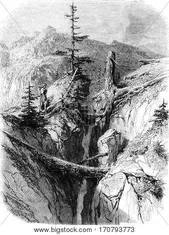 The mountain splits, vintage engraved illustration. Magasin Pittoresque 1852.