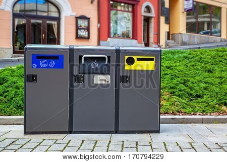 Three modern refuse bins in traditional europe city