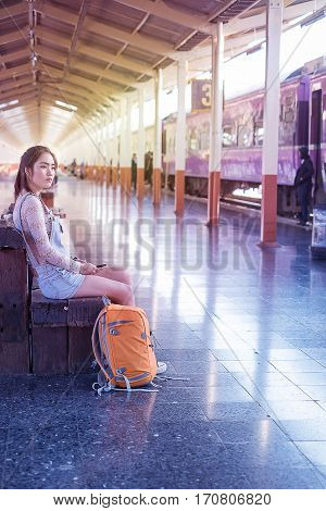 Asian Lady Traveler Backpack City Concept.with train station
